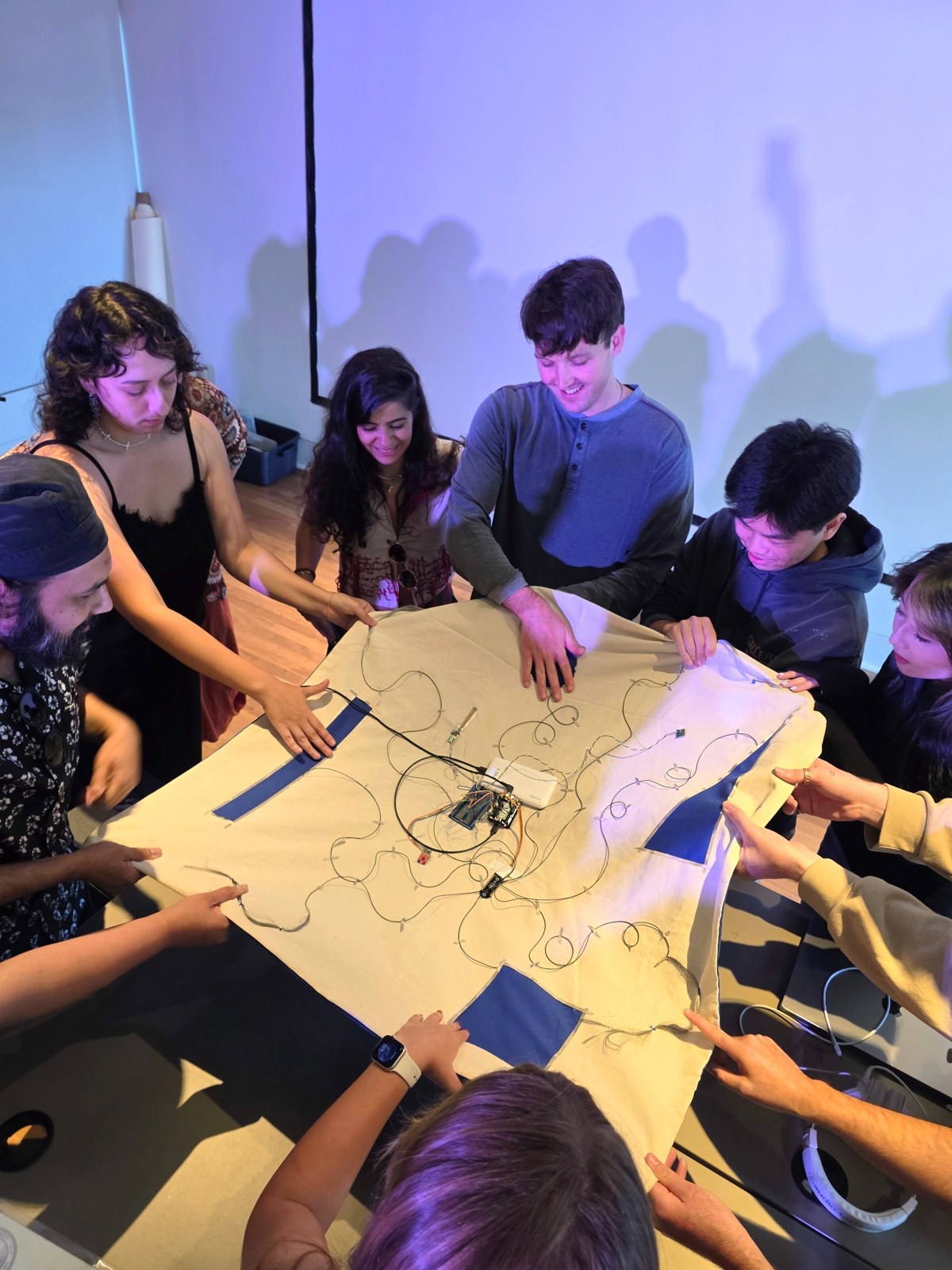 Participants working together on an interactive textile piece