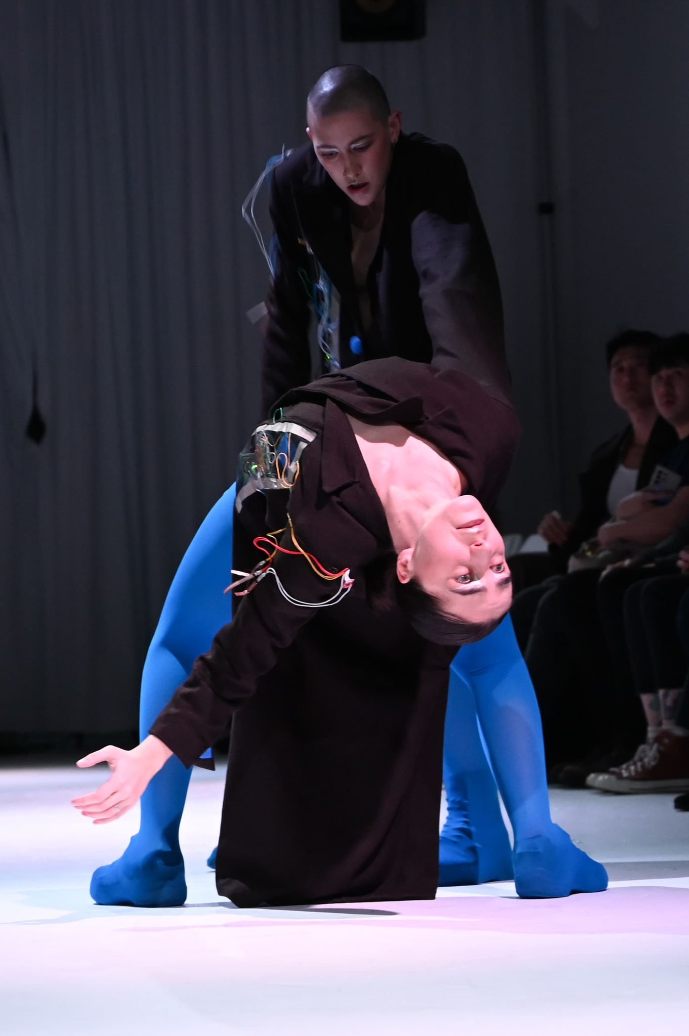 Garment, electronics, and movement in a backbend.